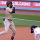 Fernando Tatis Jr. covers one eye with his hand while rounding the bases after homering off Trevor Bauer on Saturday.